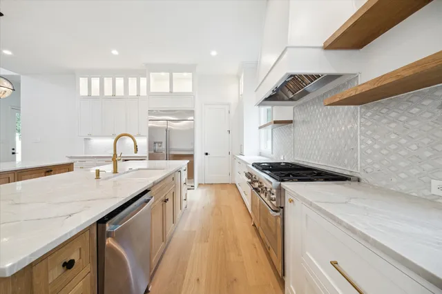 a kitchen with a sink stove and cabinets