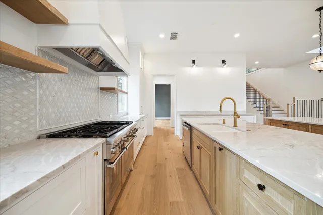 a kitchen with a sink a stove and cabinets