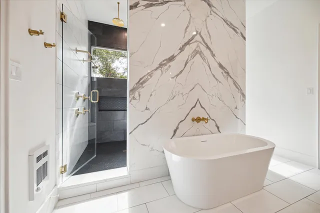 a bathroom with a bathtub and shower