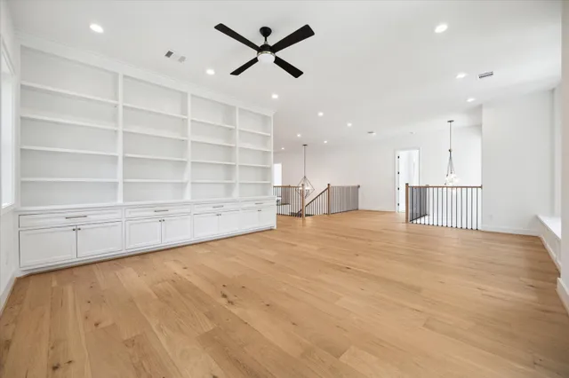 a view of empty room with wooden floor and window