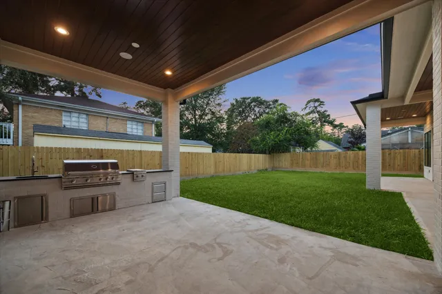 a open kitchen with stainless steel appliances granite countertop a stove and a refrigerator