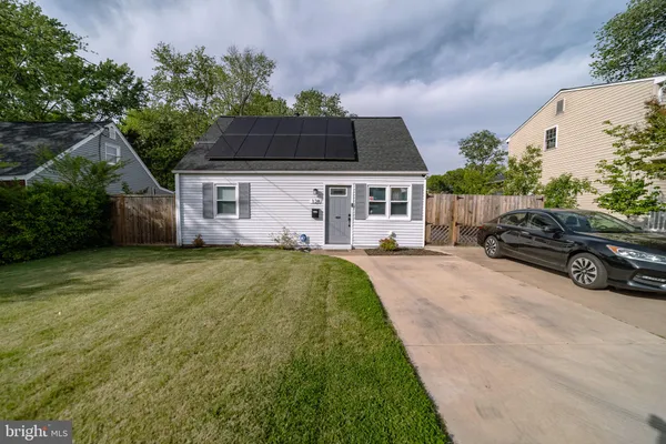 a view of a house with a yard patio and fire pit