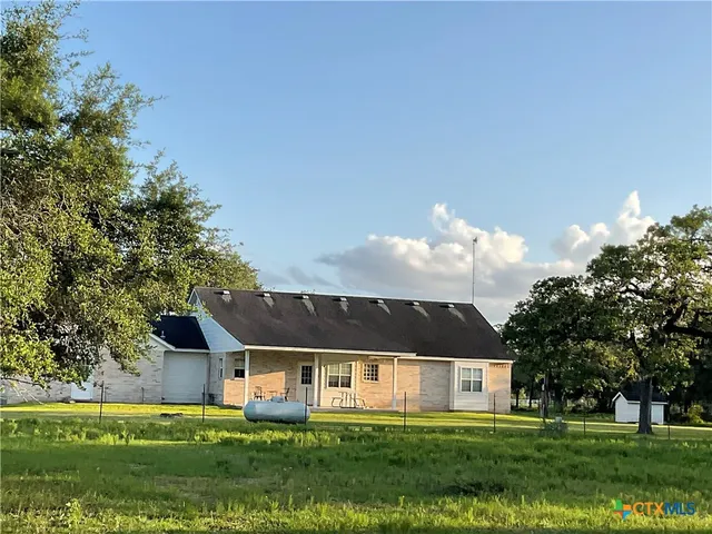 a bed sitting in a room next to a window