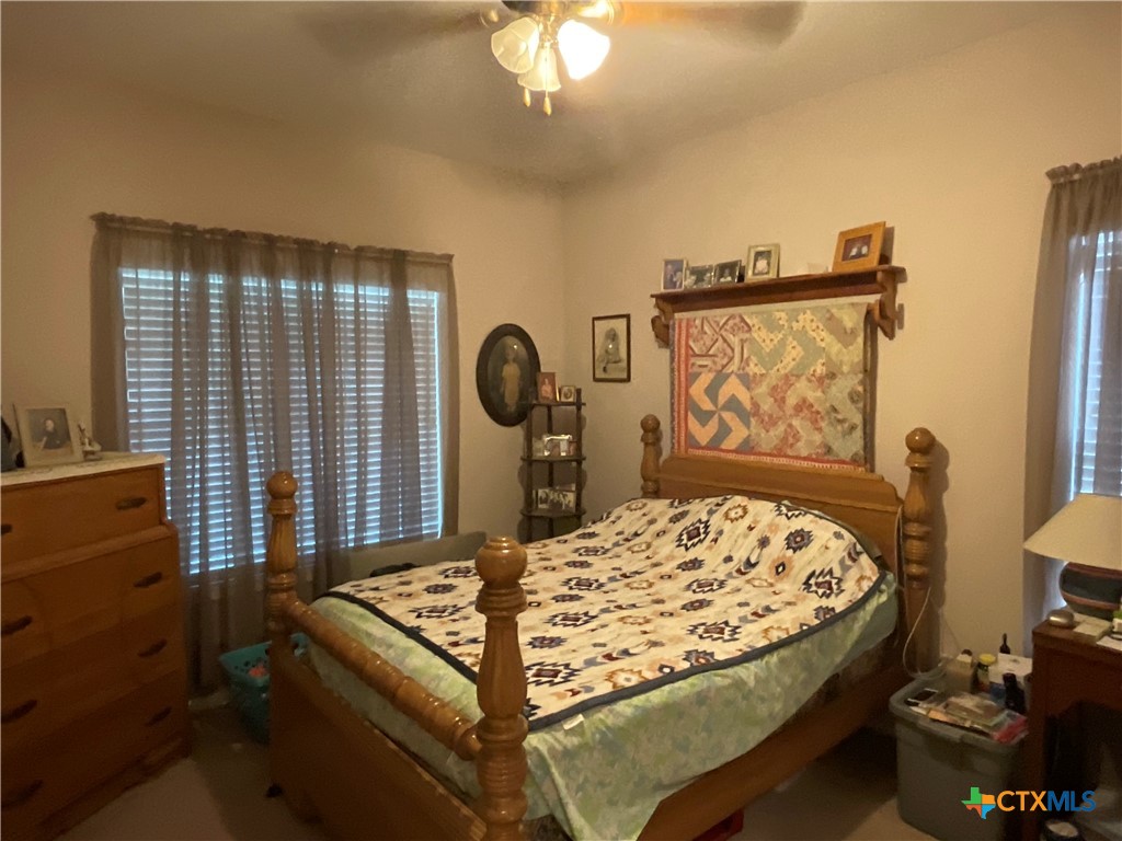 2826 Cattle Guard Road Cuero, TX 77954 - Photo 15 of 33 a bed sitting in a room next to a window