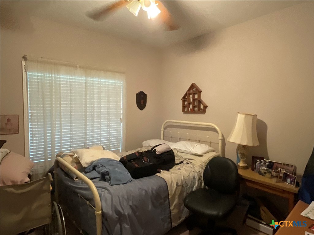 2826 Cattle Guard Road Cuero, TX 77954 - Photo 16 of 33 a bedroom with a bed and a lounge chair