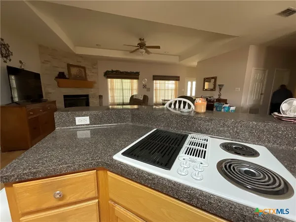 a kitchen with granite countertop cabinets stainless steel appliances and a sink