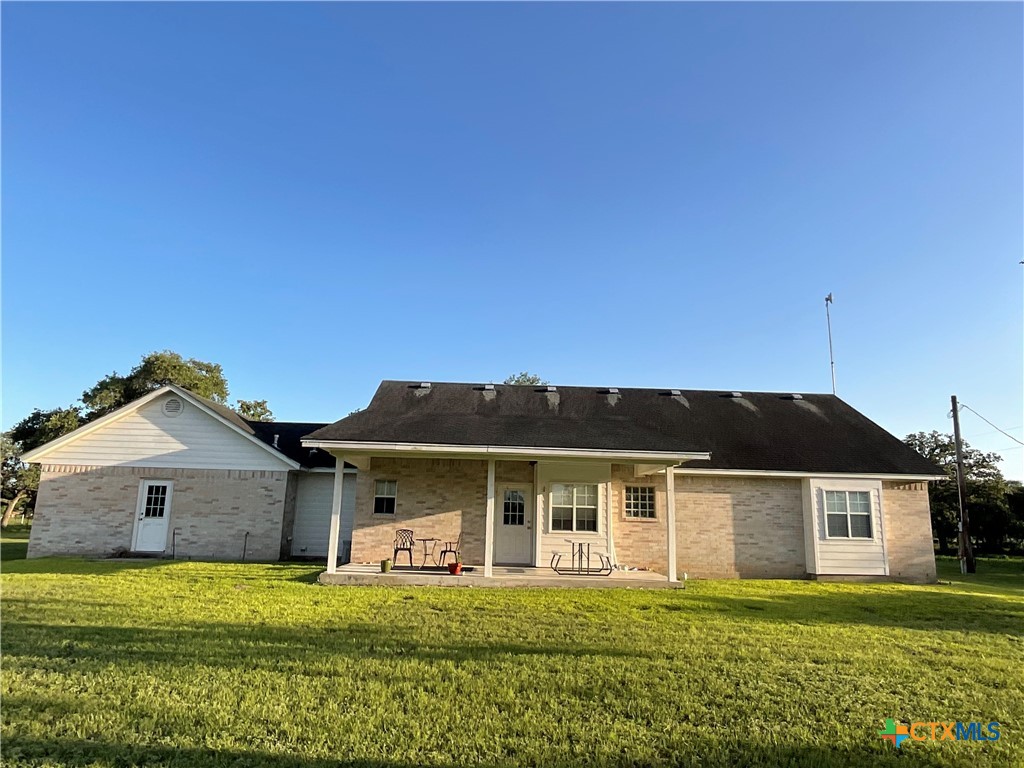 2826 Cattle Guard Road Cuero, TX 77954 - Photo 4 of 33 a front view of a house with a yard and garage
