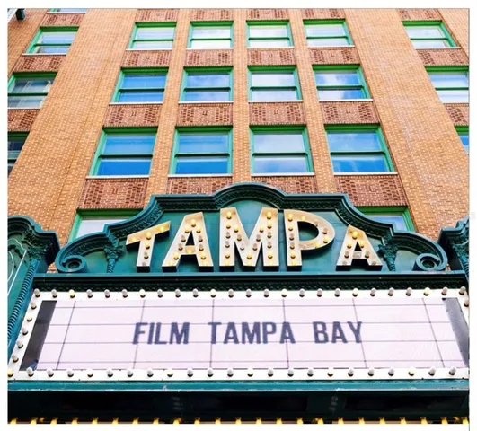 a group of people sitting in a yard