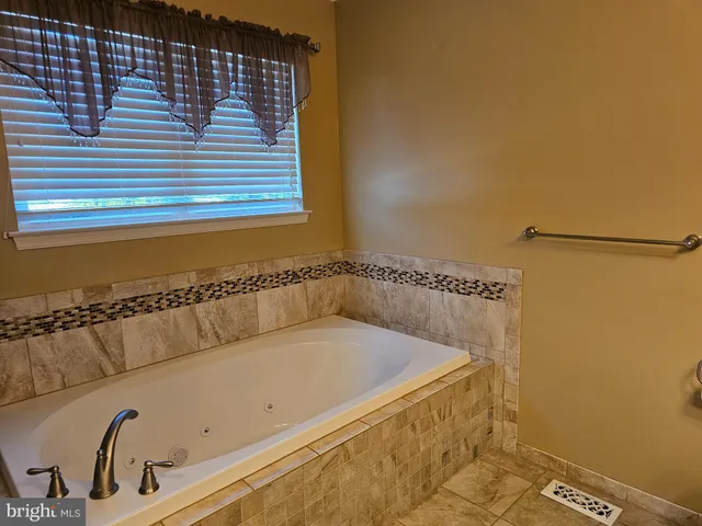 a bathroom with a bathtub and shower