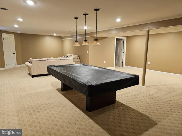 a room with pool table and a chandelier