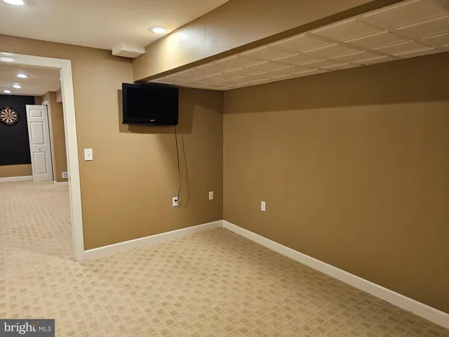 a view of a livingroom with an empty space and a flat screen tv
