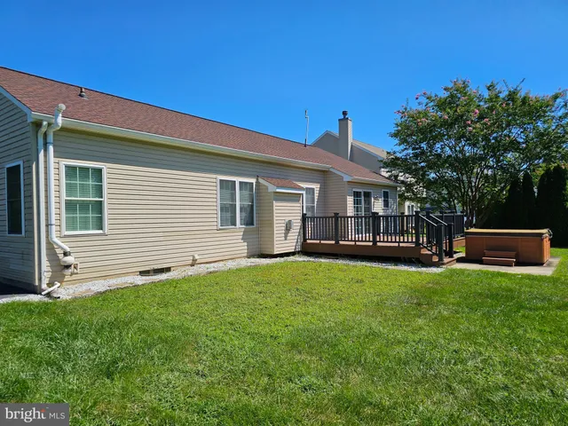 a view of a house with a yard and porch