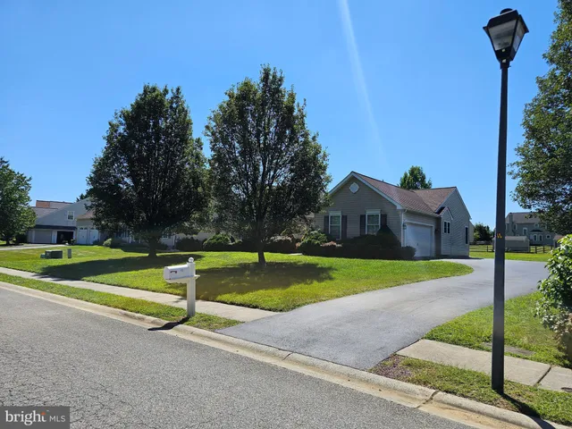 a view of a house with swimming pool and a yard