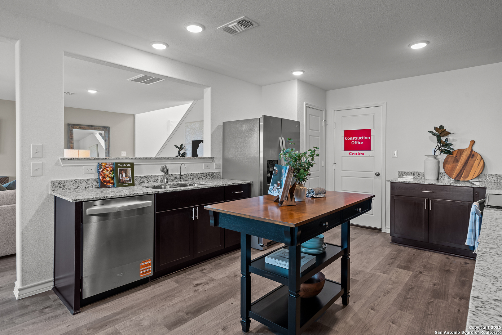 4138 Bermuda Lane Seguin, TX 78155 - Photo 7 of 24 a kitchen with stainless steel appliances granite countertop a sink a stove a refrigerator a microwave a dining table and chairs