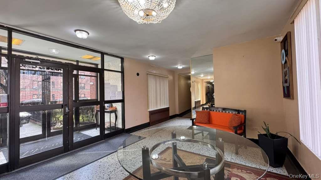 141-05 Pershing Crescent, Unit 416 Queens, NY 11435 - Photo 13 of 17 a room with furniture and a window