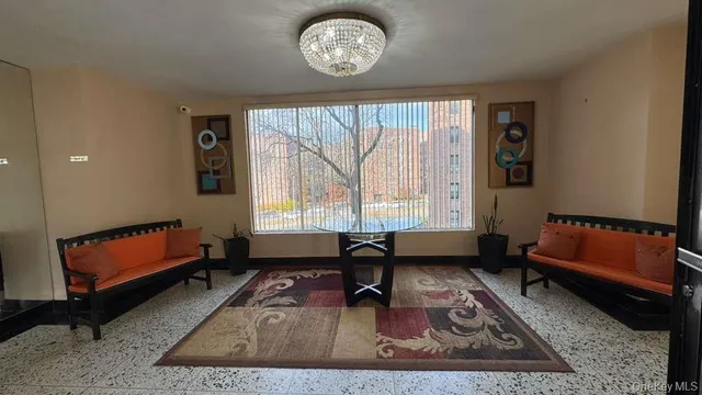 a living room with furniture rug and window