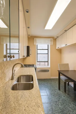 a bathroom with a sink a bathtub and next to a window