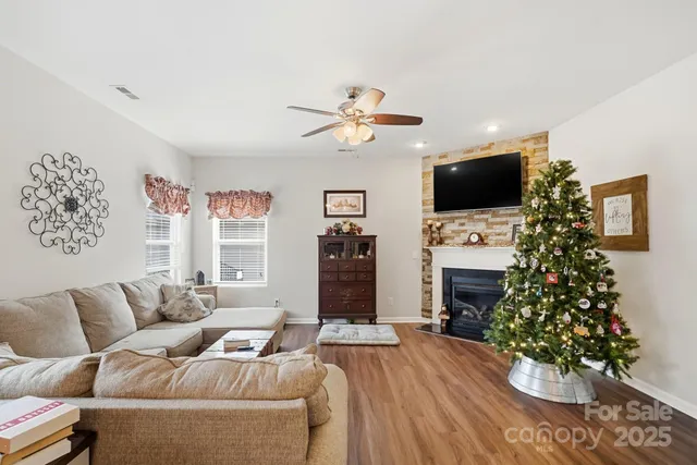 a living room with furniture a flat screen tv and a fireplace