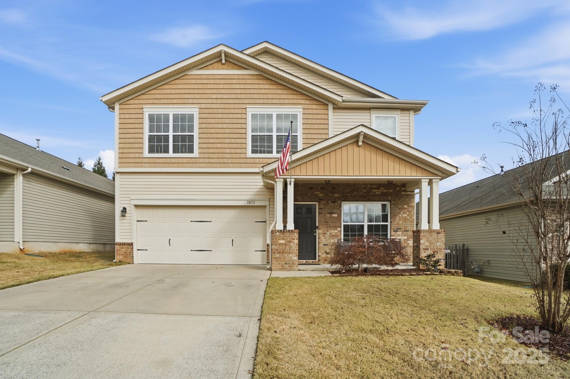 5033 Haven Lodge Road Matthews, NC 28104 - Photo 2 of 37 a front view of a house with a yard and garage
