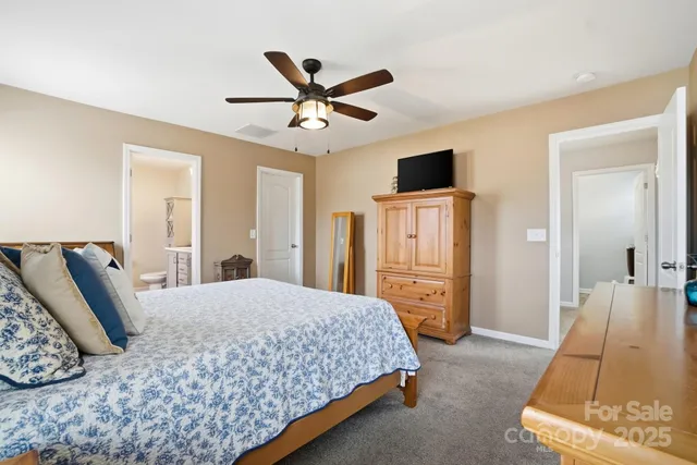 a bed room with a bed and a chair