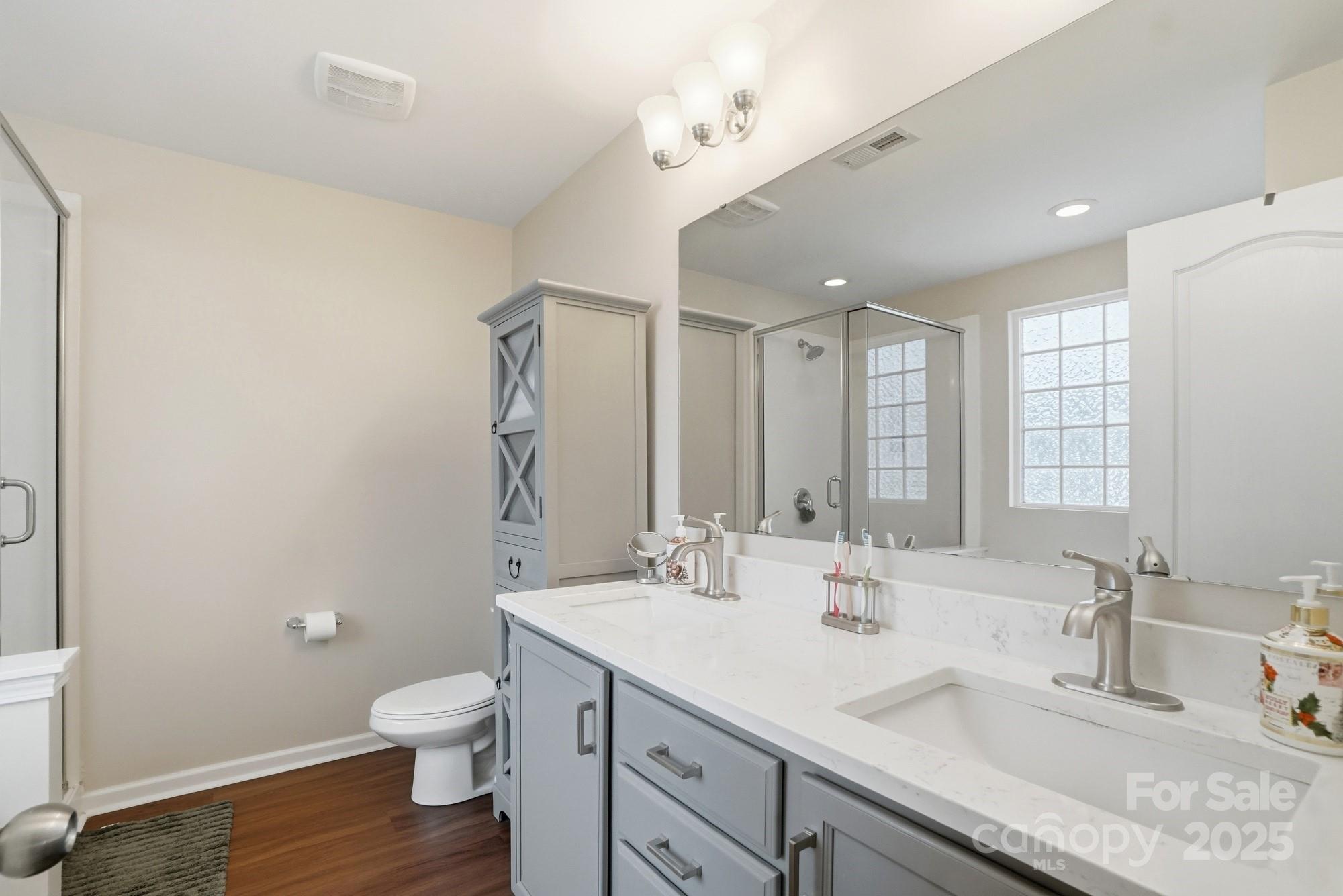 5033 Haven Lodge Road Matthews, NC 28104 - Photo 23 of 37 a bathroom with a sink double vanity and a toilet