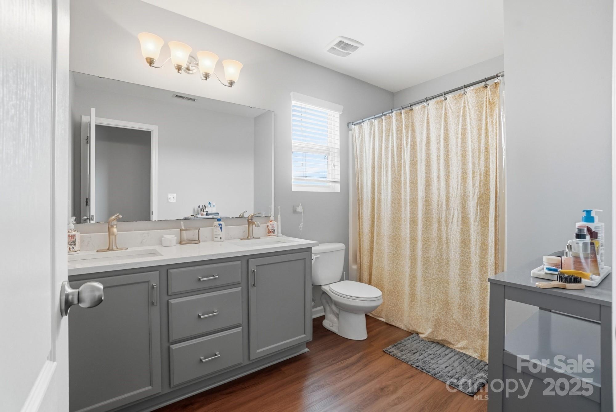 5033 Haven Lodge Road Matthews, NC 28104 - Photo 26 of 37 a bathroom with a sink toilet a mirror and vanity