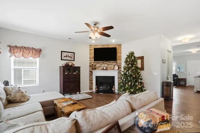 a living room with furniture a fireplace and a flat screen tv