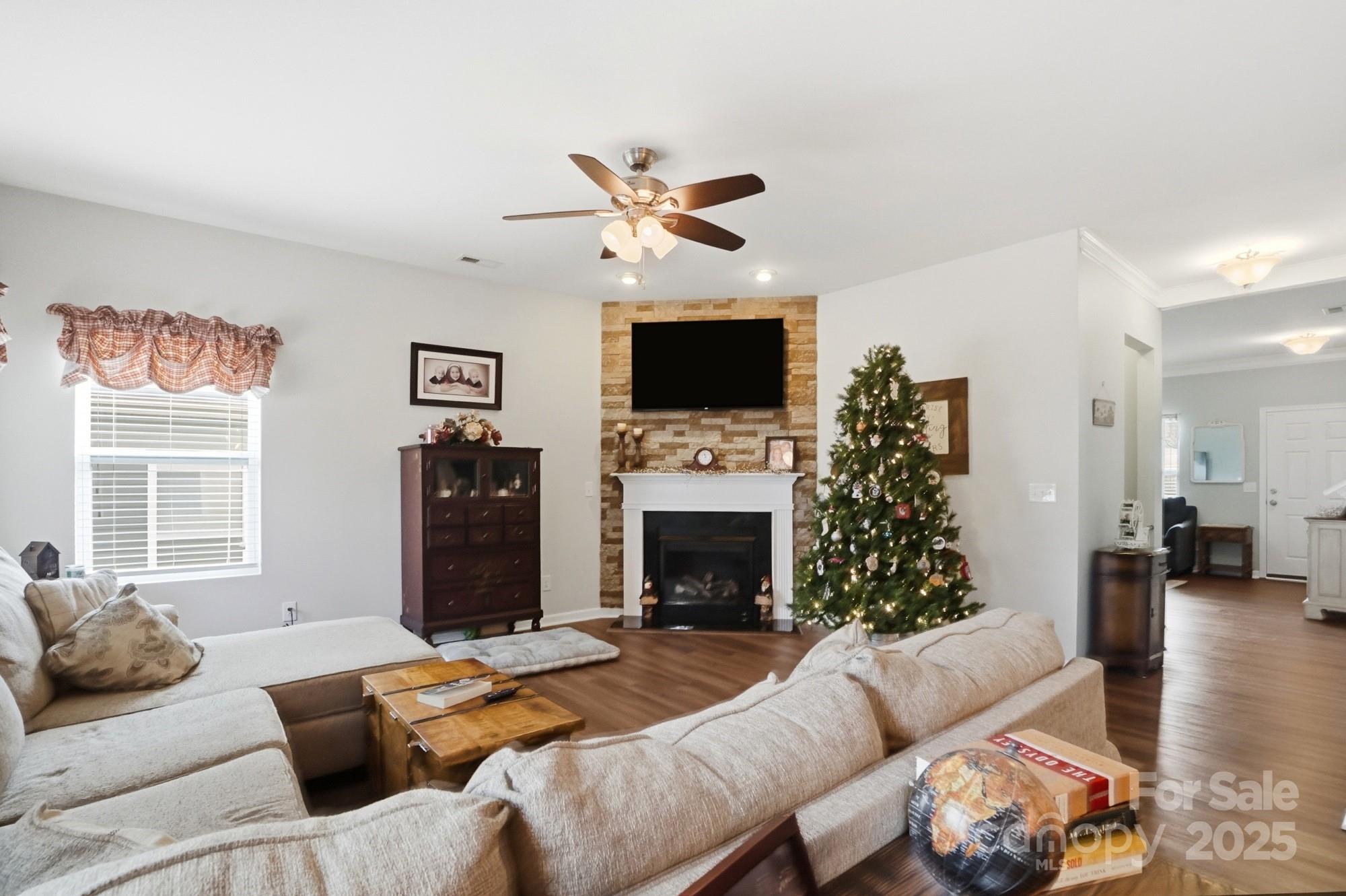 5033 Haven Lodge Road Matthews, NC 28104 - Photo 8 of 37 a living room with furniture a fireplace and a flat screen tv
