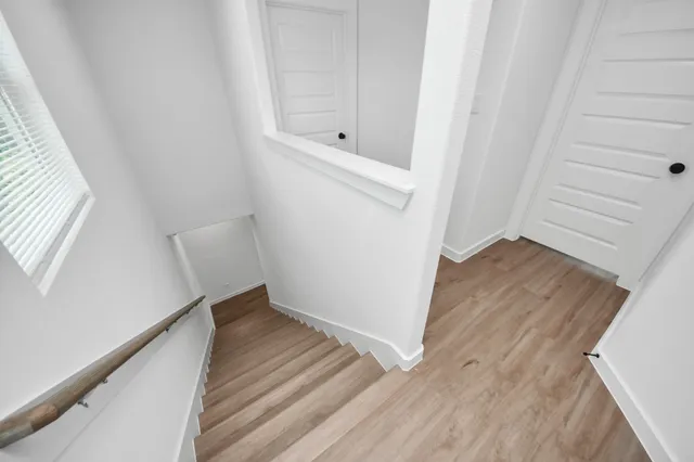a view of an empty room and wooden floor