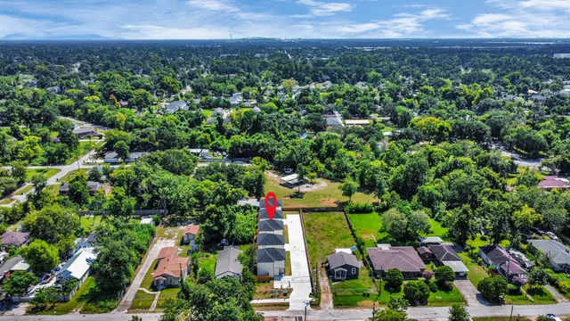 an aerial view of a houses with a yard