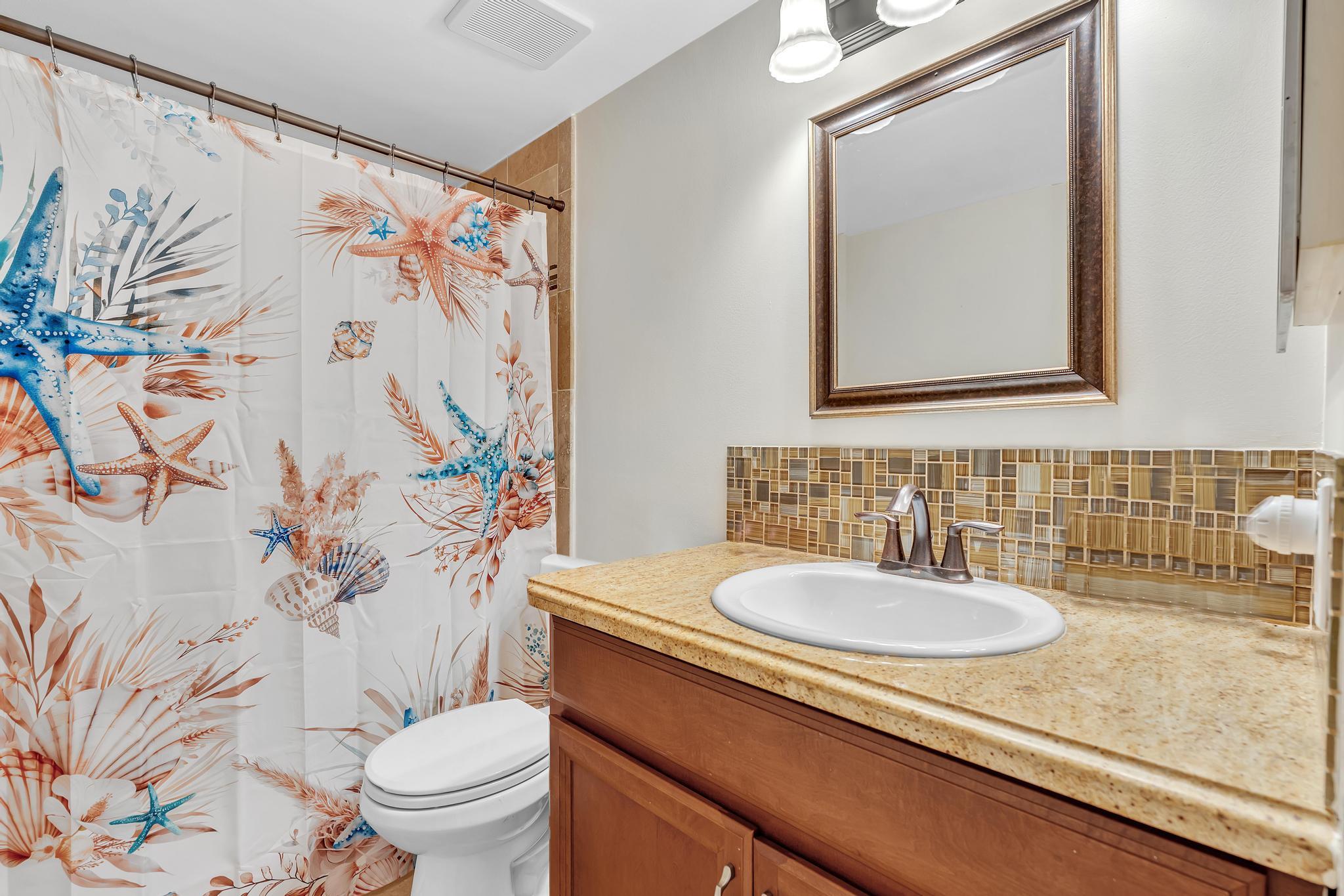 17372 Boca Club Boulevard, Unit 405 Boca Raton, FL 33487 - Photo 50 of 74 a bathroom with a sink and a mirror