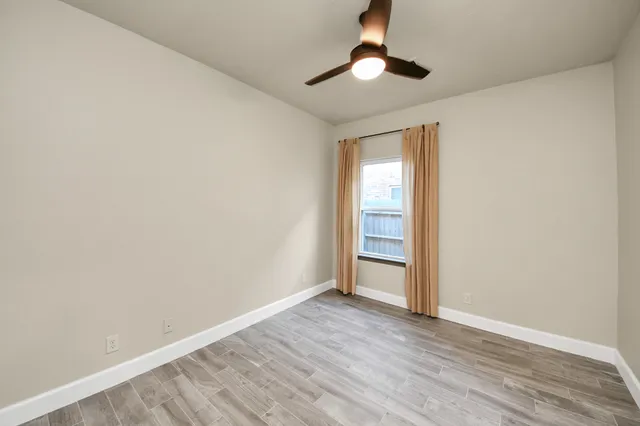 a spacious bedroom with a bed and a table