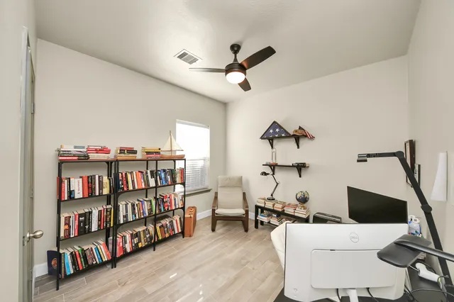 a room with a wooden floor and a white wall