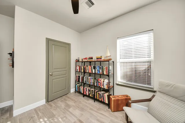 a living room with lots of furniture and a book shelf