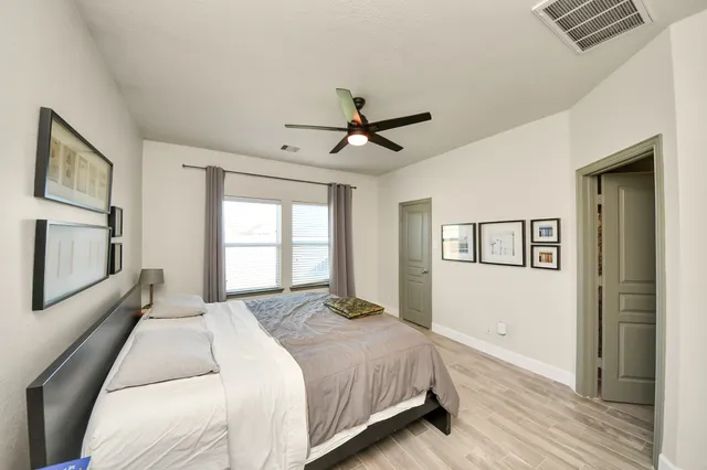 a living room with furniture a book shelf and a window