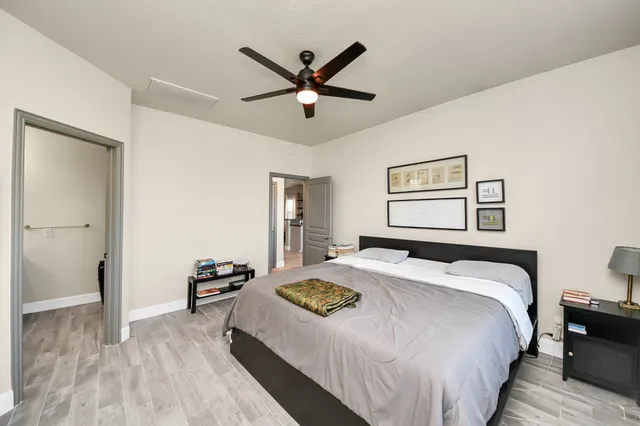 a bedroom with a large bed and a chandelier