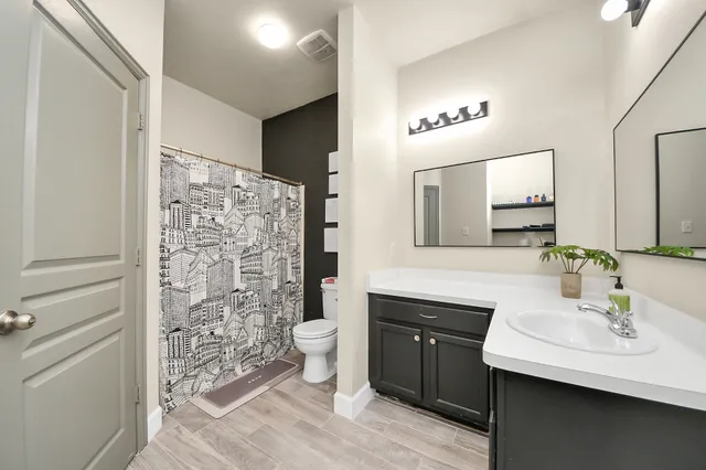 a bedroom with a bed and a ceiling fan