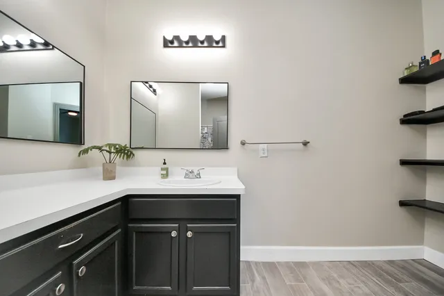 a bathroom with a sink a toilet and shower
