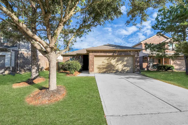 a sign board with a small yard and wooden fence