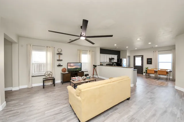 a living room with furniture and a wooden floor