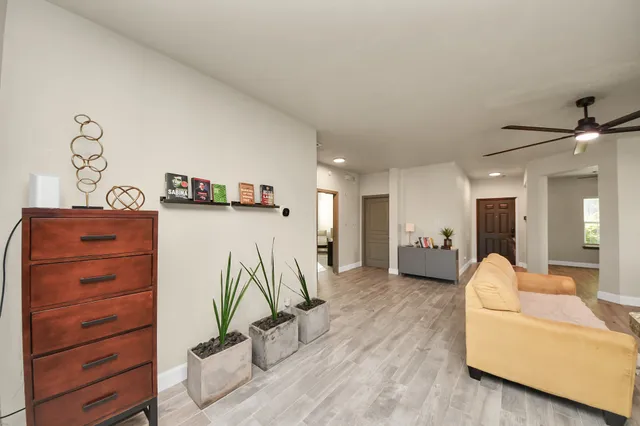 a living room with furniture and a wooden floor
