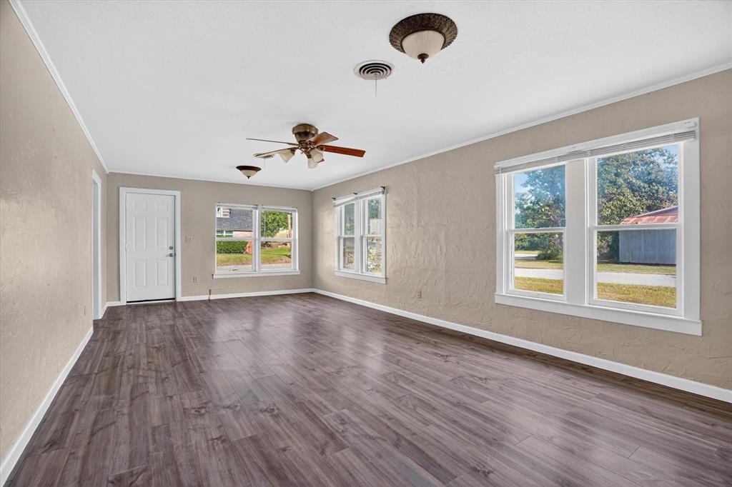 320 North 2nd Street Jacksboro, TX 76458 - Photo 6 of 16 a view of an empty room with a window and wooden floor