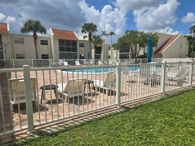 a view of a house with a small yard and plants