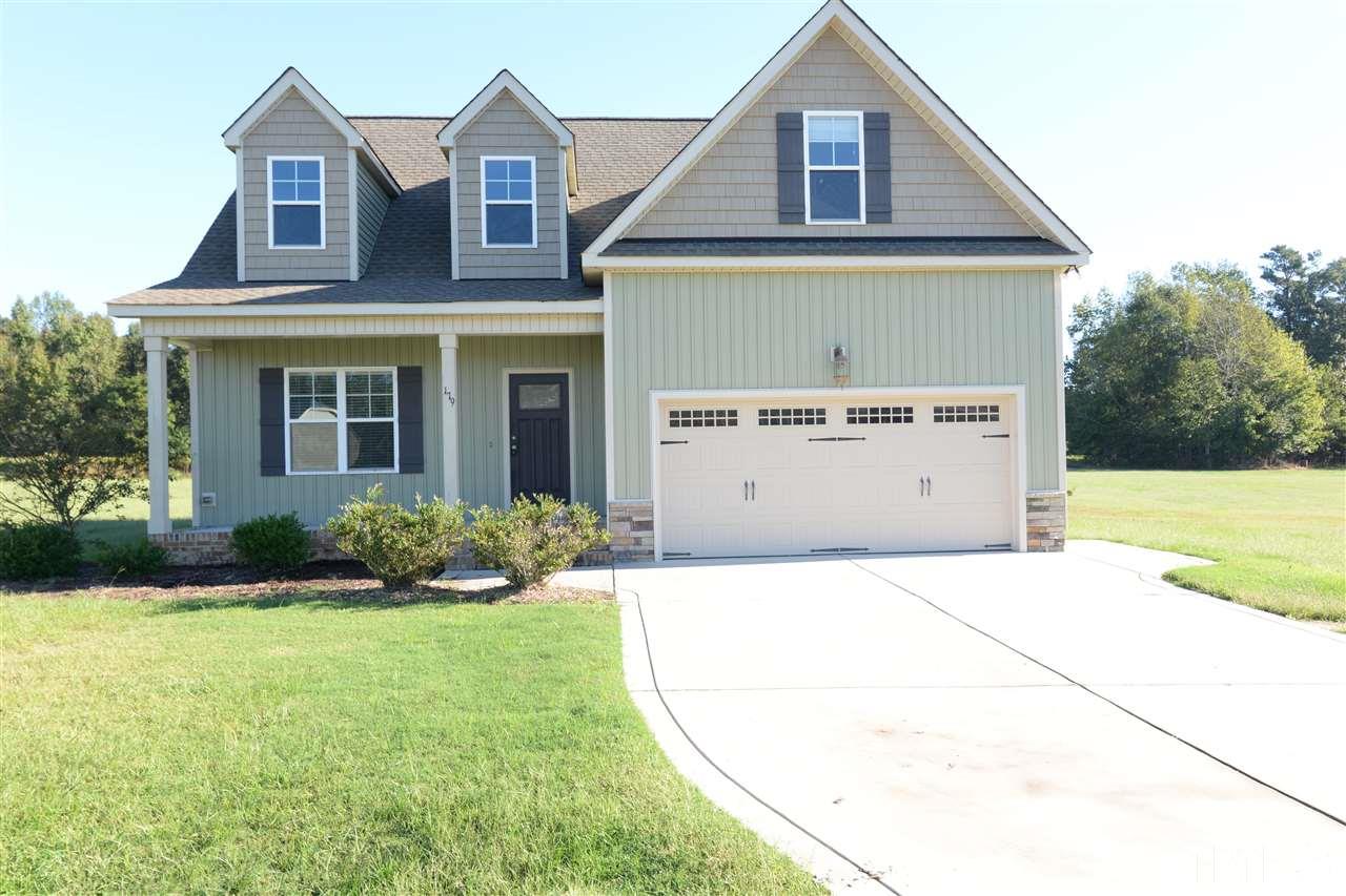 179 Red Wood Road Zebulon, NC 27597 - Photo 1 of 25 a front view of a house with a yard and garage