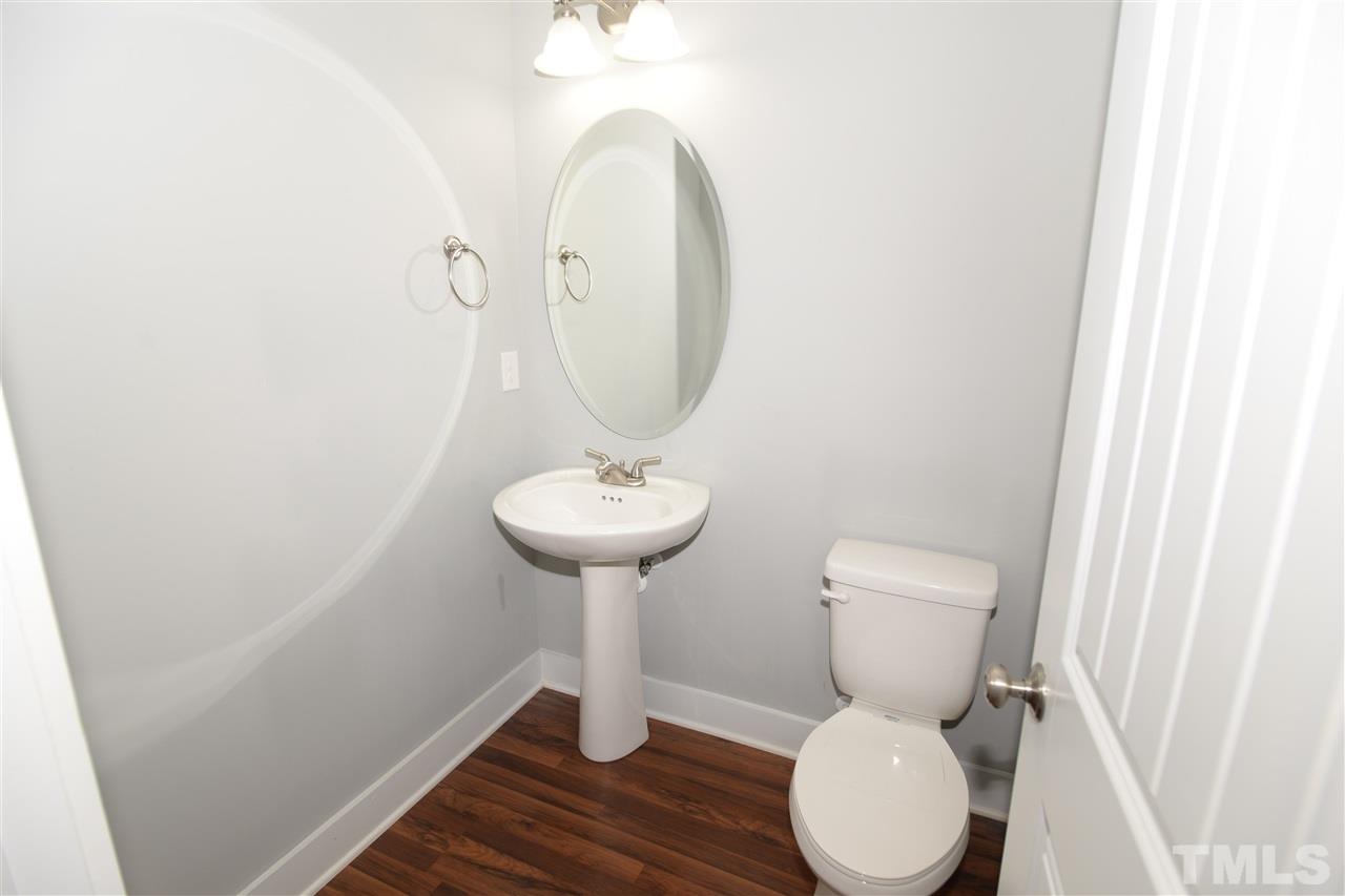 179 Red Wood Road Zebulon, NC 27597 - Photo 12 of 25 a bathroom with a toilet sink and mirror