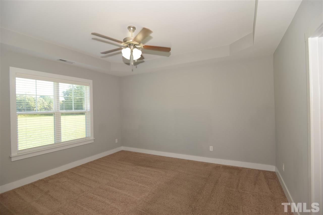 179 Red Wood Road Zebulon, NC 27597 - Photo 14 of 25 an empty room with a window and a fan