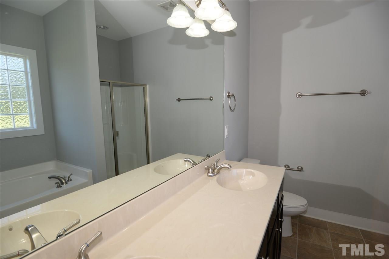 179 Red Wood Road Zebulon, NC 27597 - Photo 17 of 25 a bathroom with a sink and a mirror