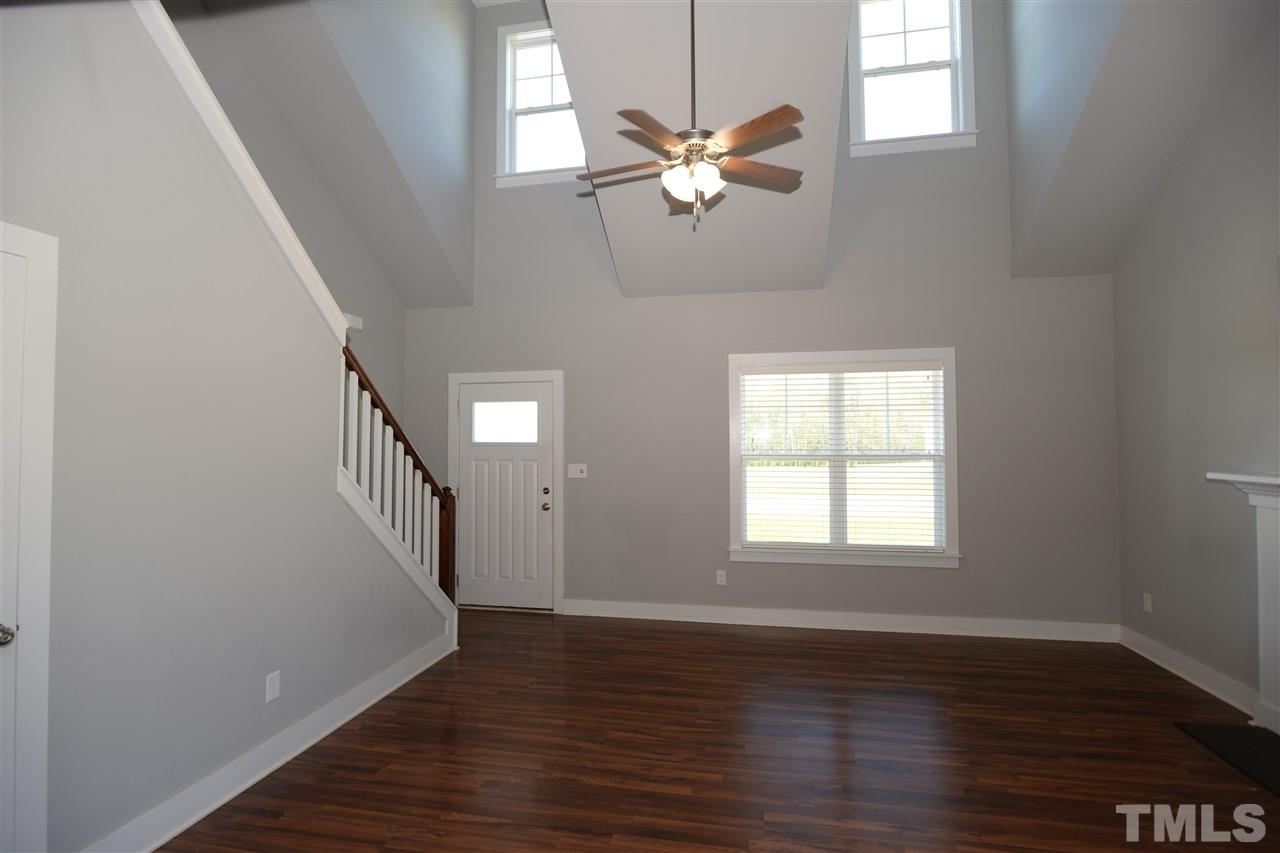 179 Red Wood Road Zebulon, NC 27597 - Photo 4 of 25 a view of an empty room with wooden floor and a window
