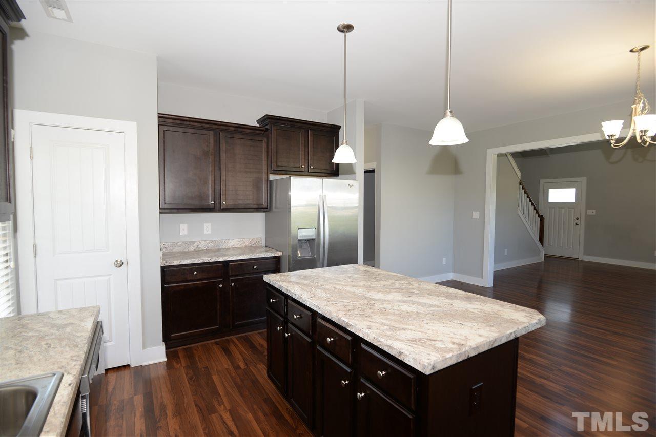 179 Red Wood Road Zebulon, NC 27597 - Photo 9 of 25 a kitchen with a sink stove and refrigerator