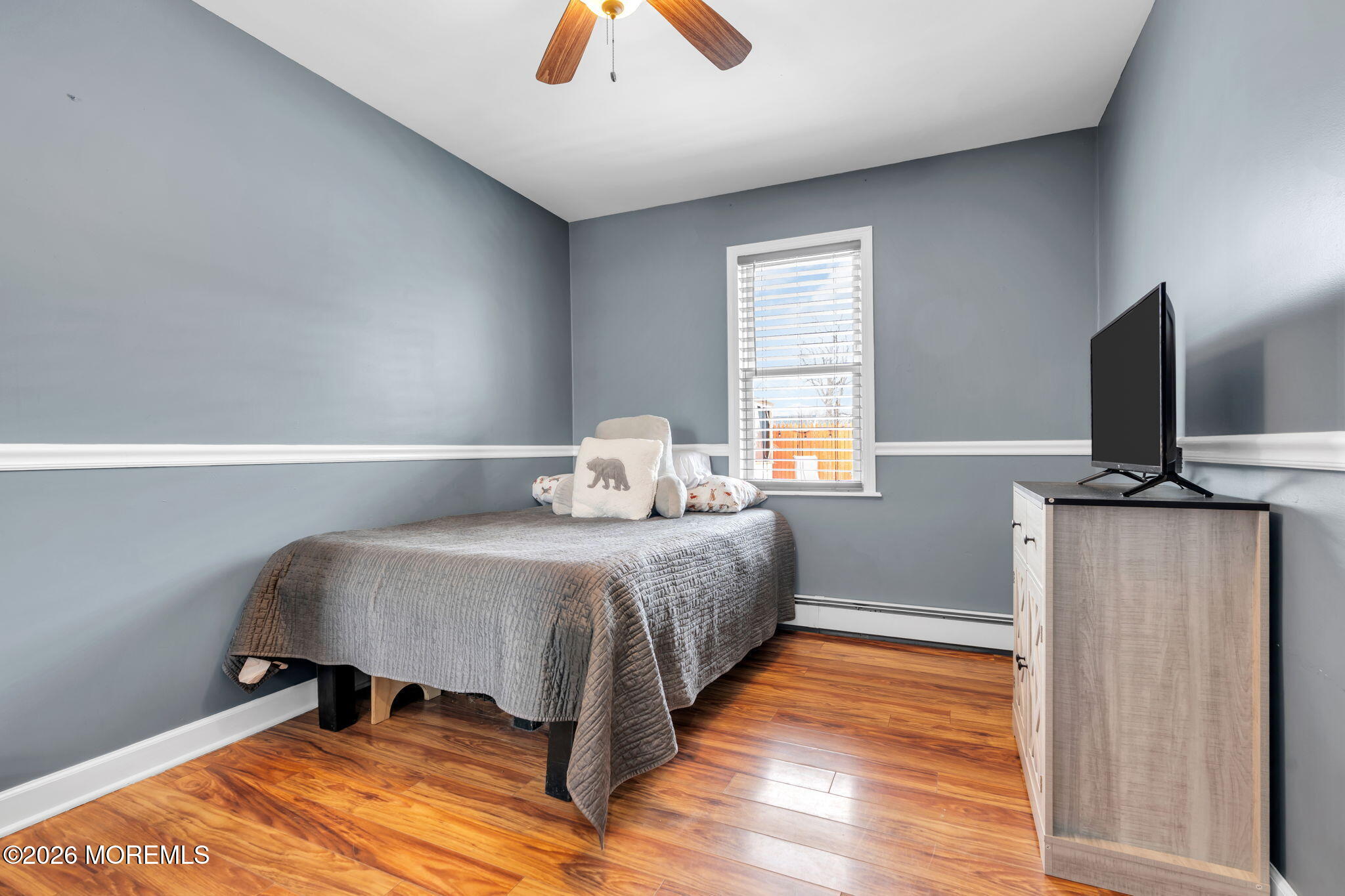 824 5th Street Union Beach, NJ 07735 - Photo 23 of 32 a bedroom with a bed and wooden floor